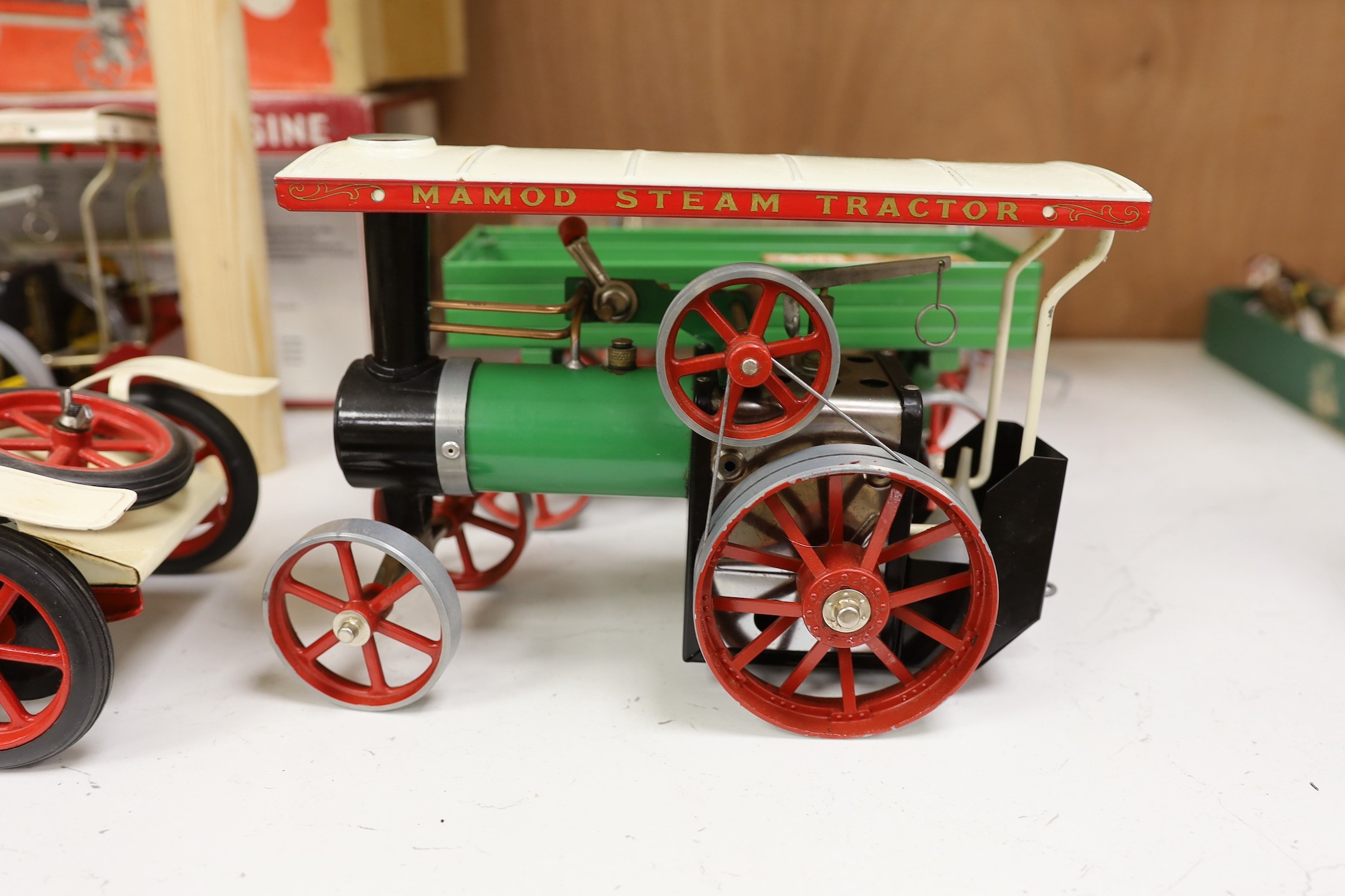 A boxed Mamod Showman's Engine and Lumbar wagon, and unboxed Steam Tractor and roadster- roadster 39 cms wide.